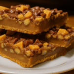 Cake Mix Toffee Bars stacked on a plate with chocolate and toffee bits