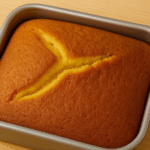 Fluffy sponge cake baked in a square pan with golden brown top