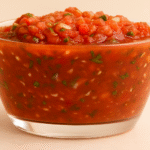 Fire Roasted Salsa in a glass bowl with fresh herbs, perfect for dipping or topping tacos