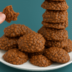 Chocolate peanut butter no-bake cookies stacked on a plate, showcasing their rich, chewy texture.