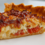 Slice of Bacon Onion Tomato Pie on a white plate with crispy bacon, caramelized onions, and fresh tomatoes
